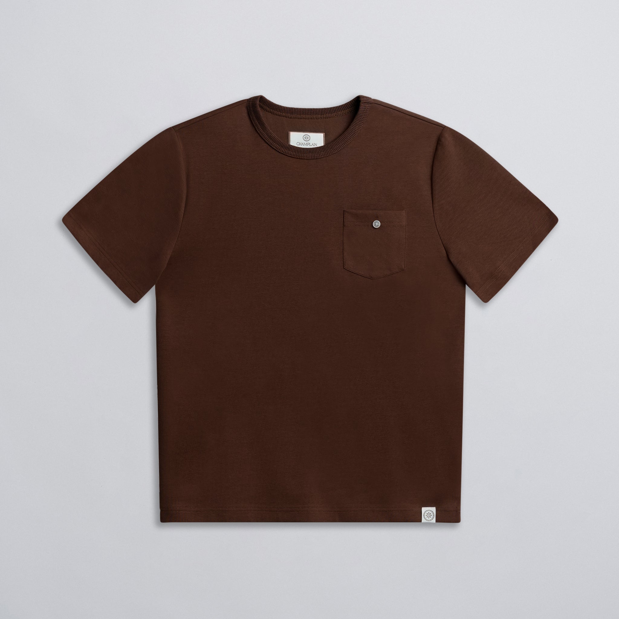 A brown crew neck t-shirt with a chest pocket and button detail on the collar.