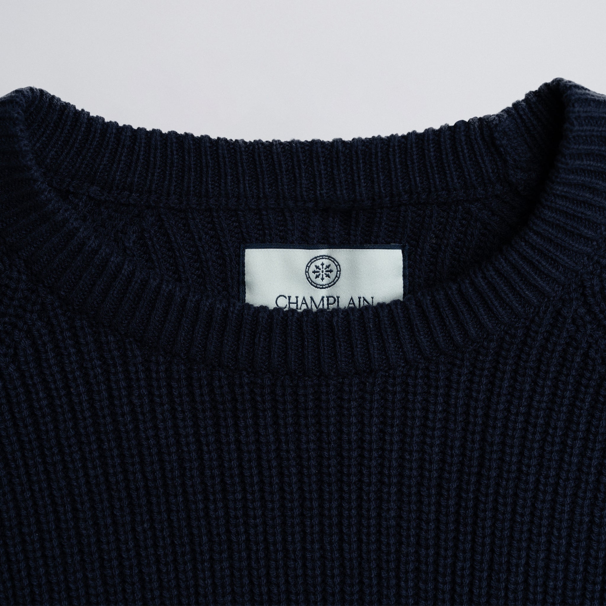 Close-up of a label on a dark blue garment.