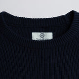 Close-up of a label on a dark blue garment.