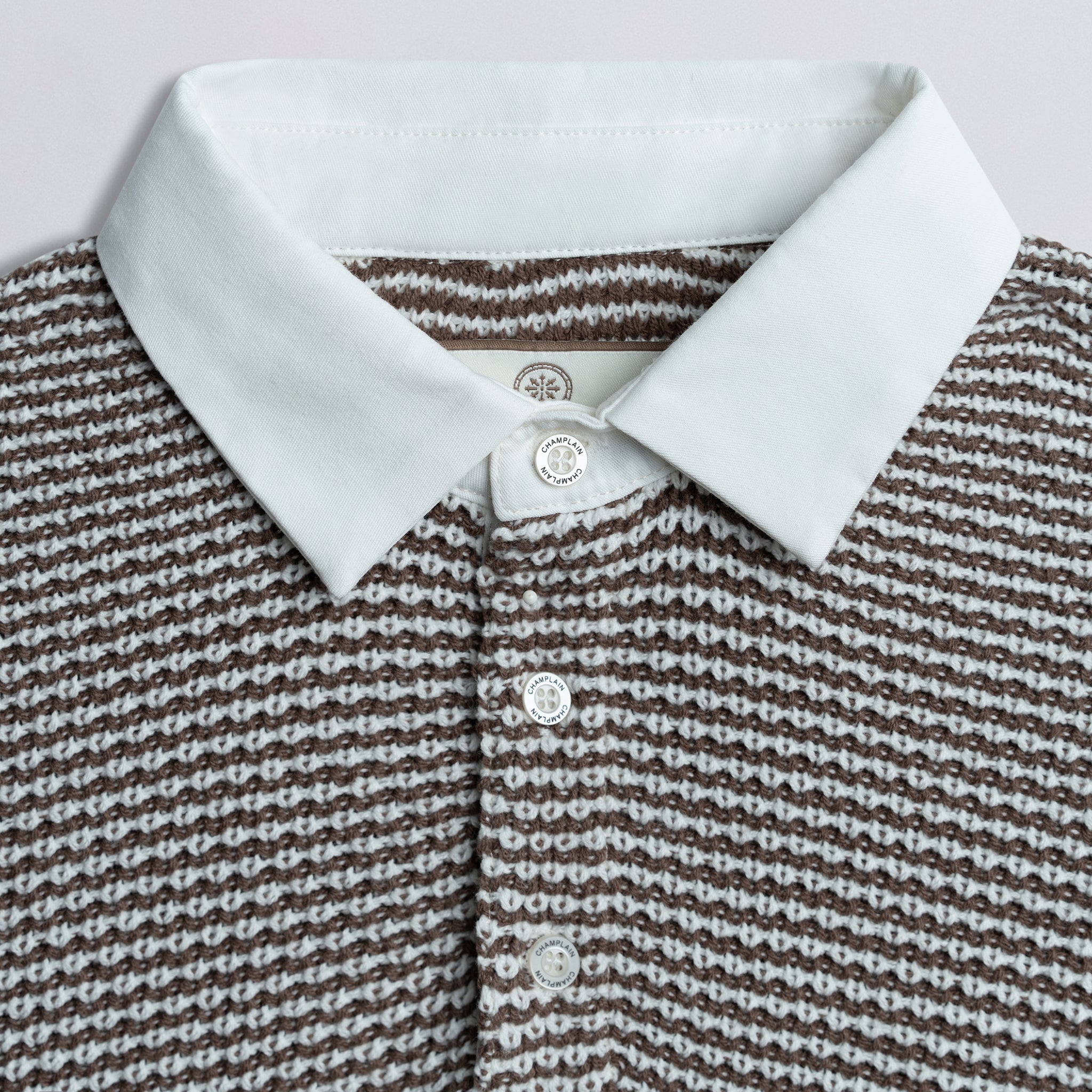 Close up of collar on a knit rugby shirt.