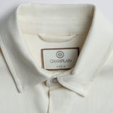 Close-up of a white shirt collar with a Champlain label.