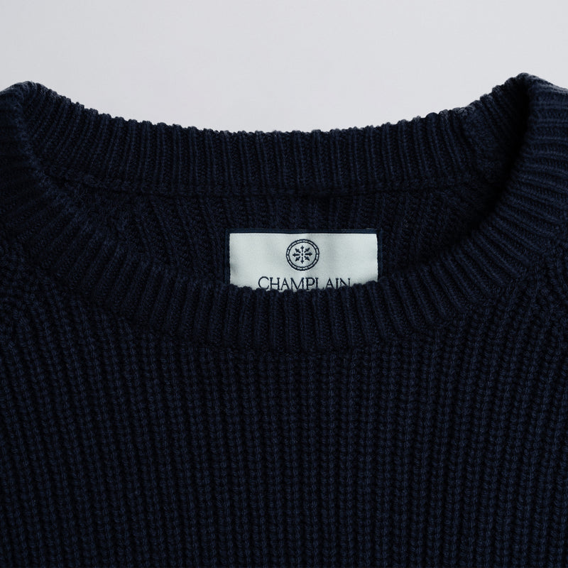 Close-up of a label on a dark blue garment.