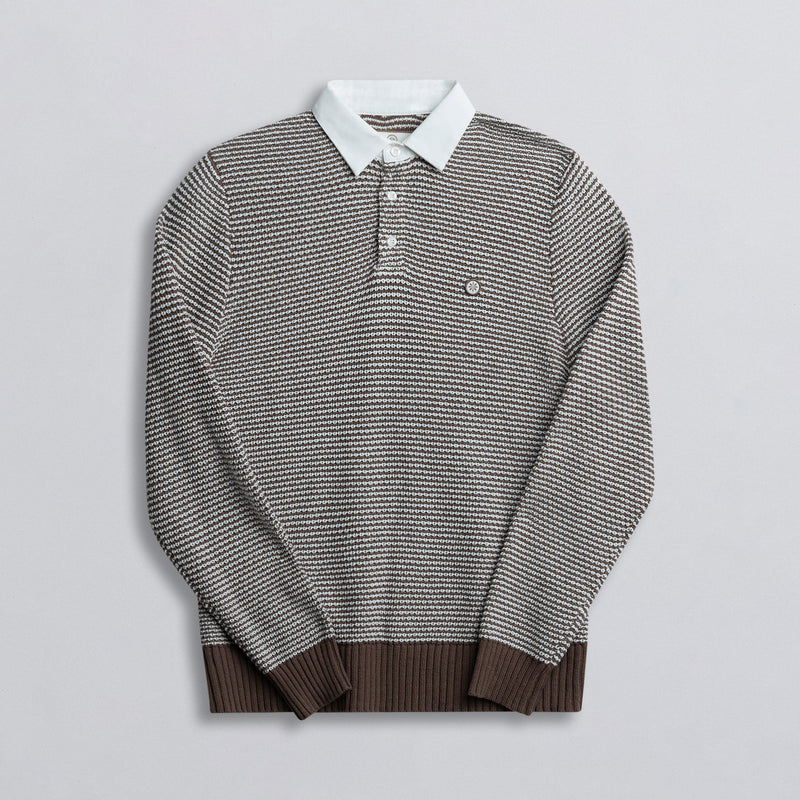 A long-sleeved rugby shirt with a striped pattern, featuring a collar and button-up design, predominantly in brown color with white and darker brown stripes.