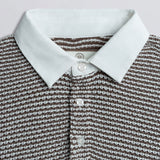Close up of collar on a knit rugby shirt.