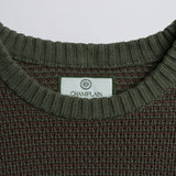 Close-up of a label on a green knitted garment.