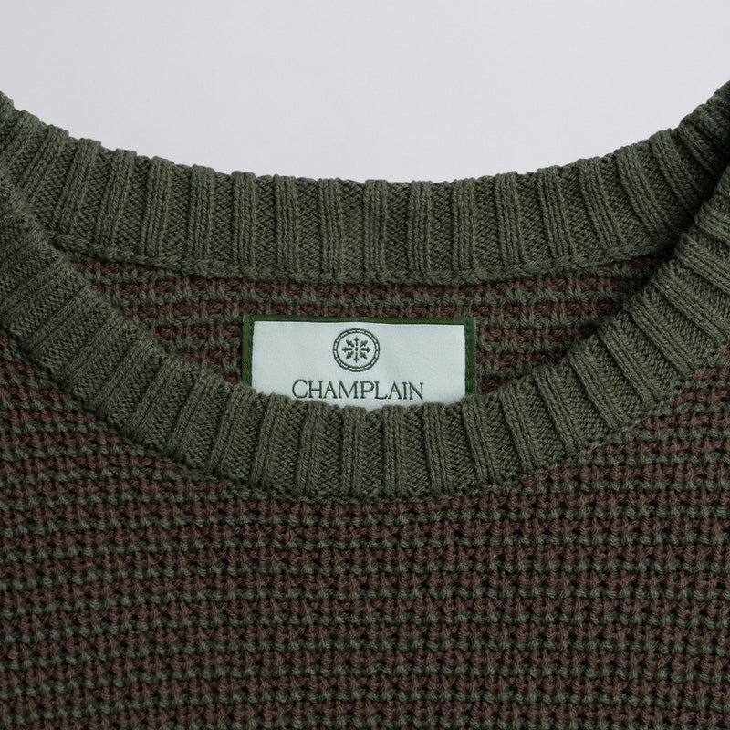 Close-up of a label on a green knitted garment.